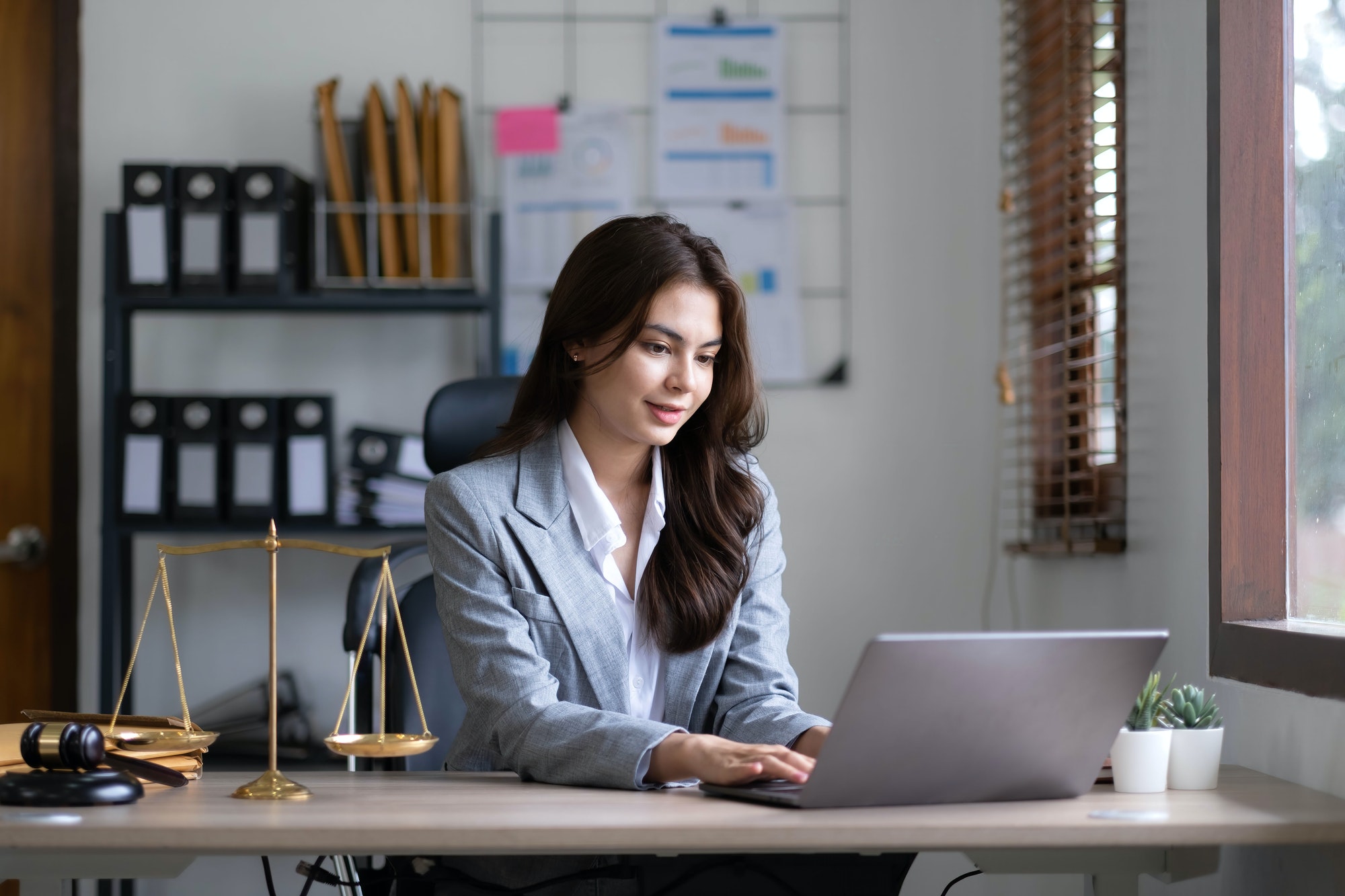 Asian lawyer woman working with a laptop computer in a law office. Legal and legal service concept.